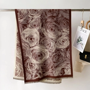 Close-up of elegant rose flower jacquard pattern and fringe edge on winter scarf