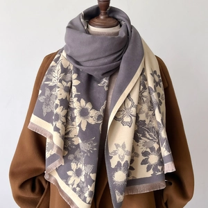 Macro shot of two-tone floral jacquard scarf with delicate fringe and soft texture