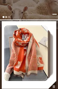 Detail of orange cat pattern scarf with dense knit texture and grey fringe tassels