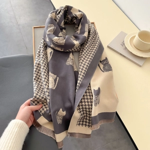 Detail of soft thick scarf featuring cat silhouette pattern and classic houndstooth weave