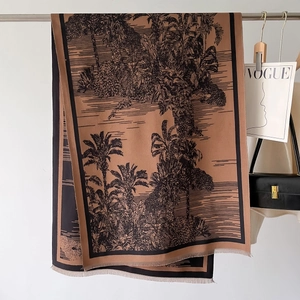 Close-up of brown tropical palm tree pattern scarf with fine tassel fringe detail