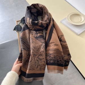 Close-up of vintage forest landscape print on thick winter scarf with fringe details