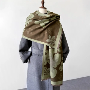 Detail of floral jacquard shawl with green flower patterns and short fringe edges
