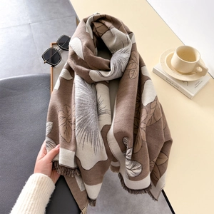 Brown and beige floral print winter shawl with short tassels on a lifestyle background