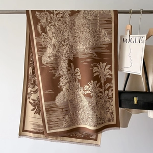 Detailed macro view of Toile de Jouy pattern on brown and beige tasseled shawl scarf