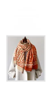 Beige knit shawl with orange geometric maze patterns and soft tassel edge details