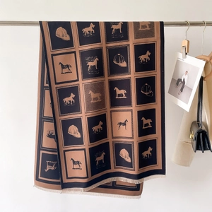 Macro detail of plaid horse motif scarf with premium fringe edges in black and caramel