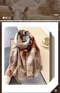 Close-up of thick gradient knit scarf with cat pattern and fringe detail for winter