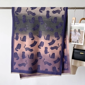 Detail of gradient purple and pink scarf featuring vintage cat patterns and fine fringe