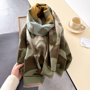 Detailed view of soft jacquard scarf featuring cute cat silhouettes and thick fringe edges