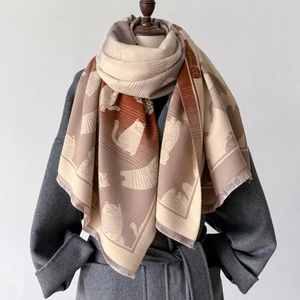 Detail of gradient cat pattern shawl scarf with tassel edges on a mannequin display