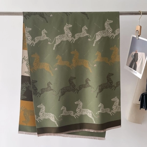 Close-up of zebra pattern print on dark green winter shawl with fine fringe edges