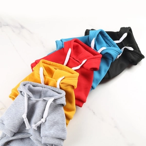 Flat lay of colorful pet hoodies in grey, yellow, red, blue, and black with drawstring hood