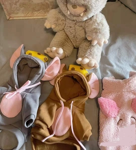 Detail of soft fleece pet hoodies in grey, brown and pink with cute animal ear designs