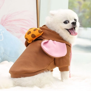 Close-up of brown pet hoodie with pink ears and orange backpack on white Pomeranian