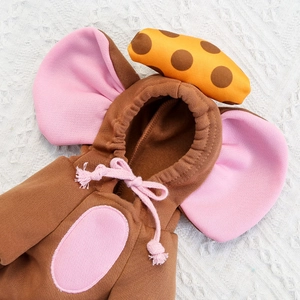 Close-up of brown fleece pet hoodie featuring pink elephant ears and orange polka dot detail