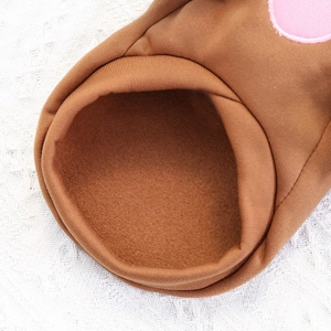 Detailed macro view of the warm fleece lining and ribbed cuff on a brown pet sweater