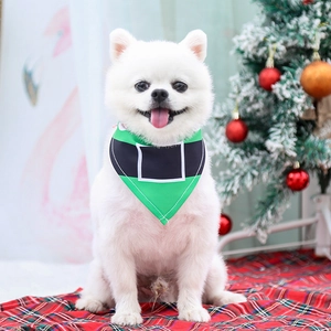 Festive green Christmas dog bandana with elf belt pattern worn by a white Pomeranian puppy