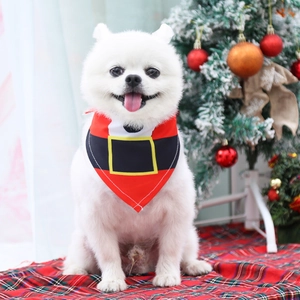 Festive Christmas dog bandana on a white Pomeranian with holiday tree background