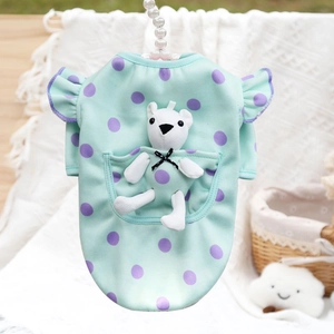 Detail of mint green polka dot pet dress featuring a cute plush bear in the back pocket
