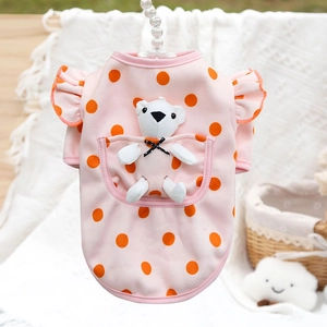 Close-up of pink polka dot pet shirt with a cute 3D white bear pocket and ruffle sleeves