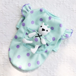 Detail of mint green pet vest with purple polka dots and a cute plush bear in the pocket
