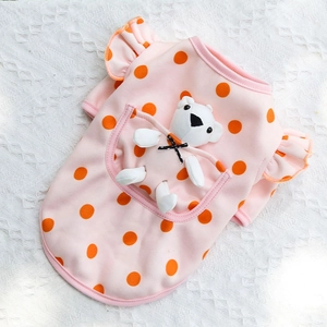 Close-up of pink polka dot pet dress featuring a cute 3D plush bear in the back pocket