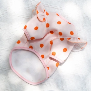 Close-up of pink pet vest with orange polka dots and ruffled shoulder details