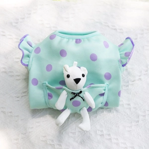 Detail of mint green pet shirt with purple polka dots and a cute white teddy bear in pocket