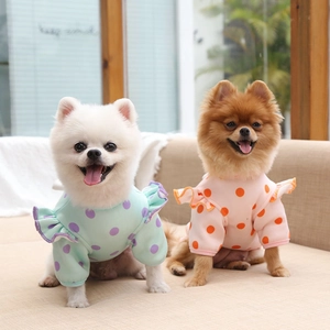 Detail of cute polka dot pet clothes with ruffled edges on sleeves and collar for dogs