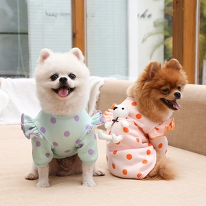 Detail of pet vest with a cute 3D teddy bear plush doll on soft polka dot fabric