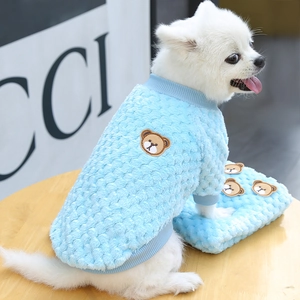 Detail of blue fleece pet sweater featuring a brown bear embroidery and ribbed cuffs