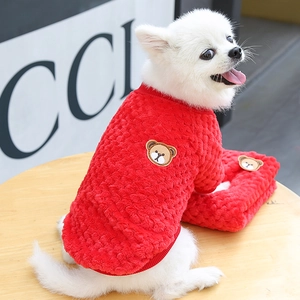 Detail of red plush dog sweater with bear embroidery and ribbed collar for small pets