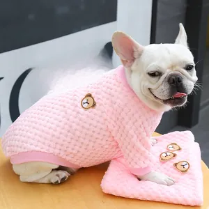 Detail of pink plaid fleece pet sweater with bear embroidery on a French bulldog