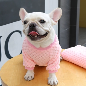 Detailed view of pink waffle knit pet sweater with ribbed cuffs on a French Bulldog