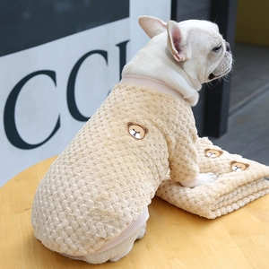 Detail of warm teddy fleece dog sweatshirt with bear embroidery and plaid texture