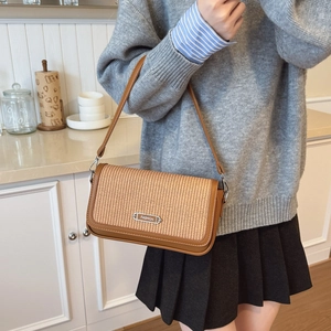 Vintage style woven straw and brown leather crossbody shoulder bag with metal plate