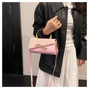 Pink PU crossbody bag featuring unique weaving texture and gold semi-circular handle details