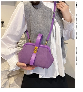 Detail of purple matte and smooth leather patchwork bag with gold twist lock