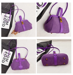 Detail view of purple matte shell bag featuring gold twist lock and protective metal feet