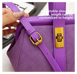 Detail of purple shell bag with adjustable shoulder strap and gold metallic buckle