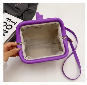 Detail view of the purple matte shell bag showing large interior space and zipper pocket