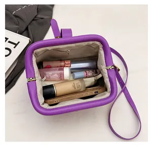 Interior view of purple shell bag showing large capacity for phone and cosmetics