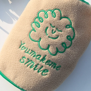 Detail of warm fleece pet vest with smile embroidery and you make me smile text