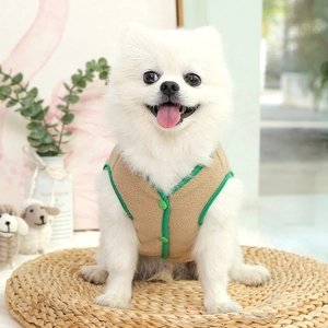 Detail shot of khaki fleece pet vest with green buttons on a small Pomeranian