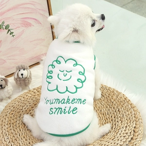 Close-up of white fleece dog vest with Youmakeme smile embroidery and green trim