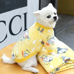 Detail of yellow fleece dog hoodie with monkey print on a fluffy white Pomeranian