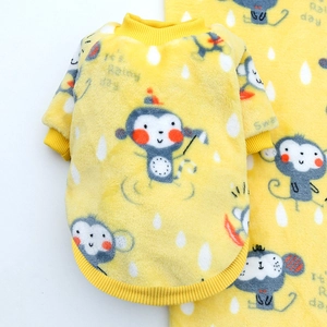 Detail of yellow fleece pet hoodie featuring cartoon monkey print and ribbed cuffs