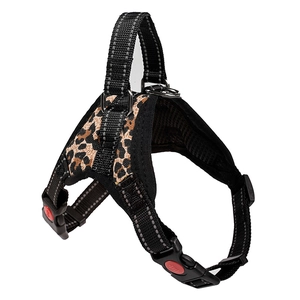 Close-up of leopard print dog harness featuring safety lock buckle and durable D-ring