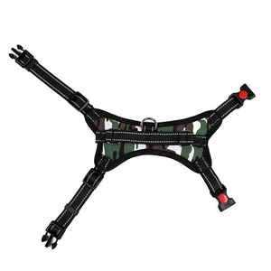 Detail of green camo dog harness with reflective nylon straps and red safety lock buckles